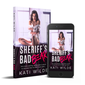 the cover for Sheriff's Bad Bear featuring a dark haired woman on a bed